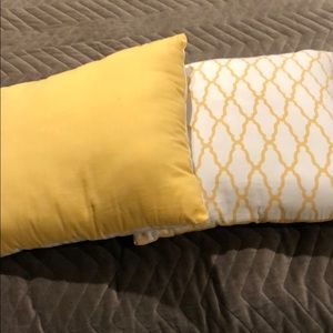 Pair of square yellow throw pillows